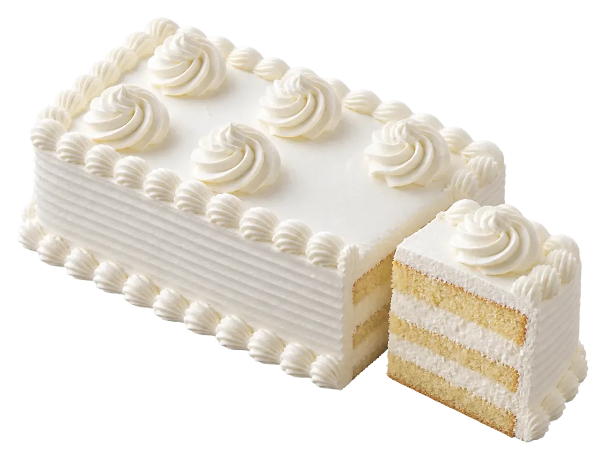 Rectangular layer cake covered and piped with whipped cream, with a slice cut out