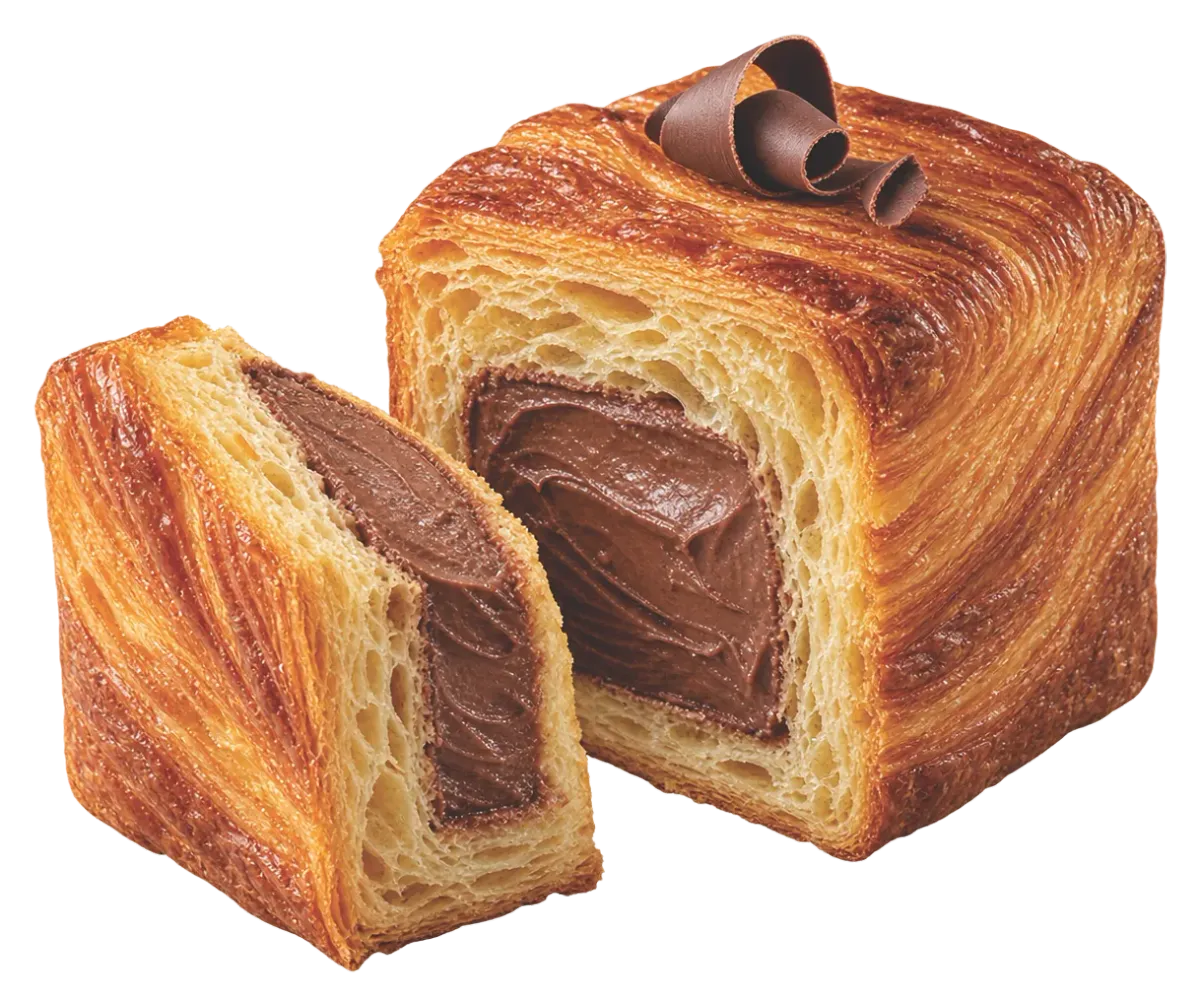 Square croissant filled with chocolate cream and cut open, topped with chocolate curls