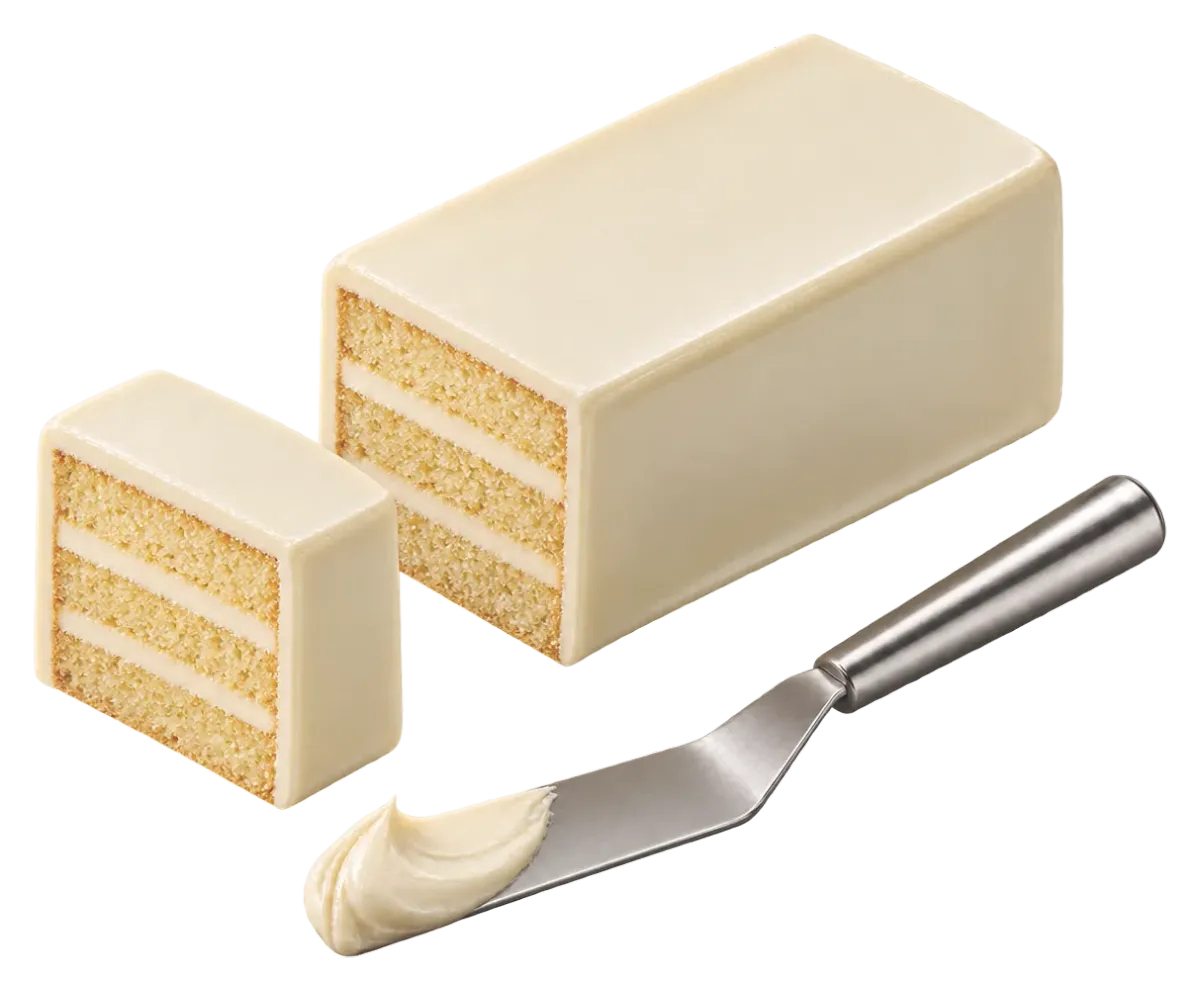 Rectangular layered cake coated in white chocolate ganache, sliced, with a spatula of ganache