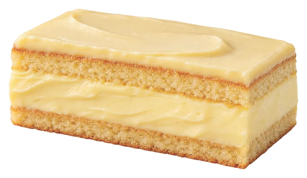Sponge cake slice layered and topped with custard cream